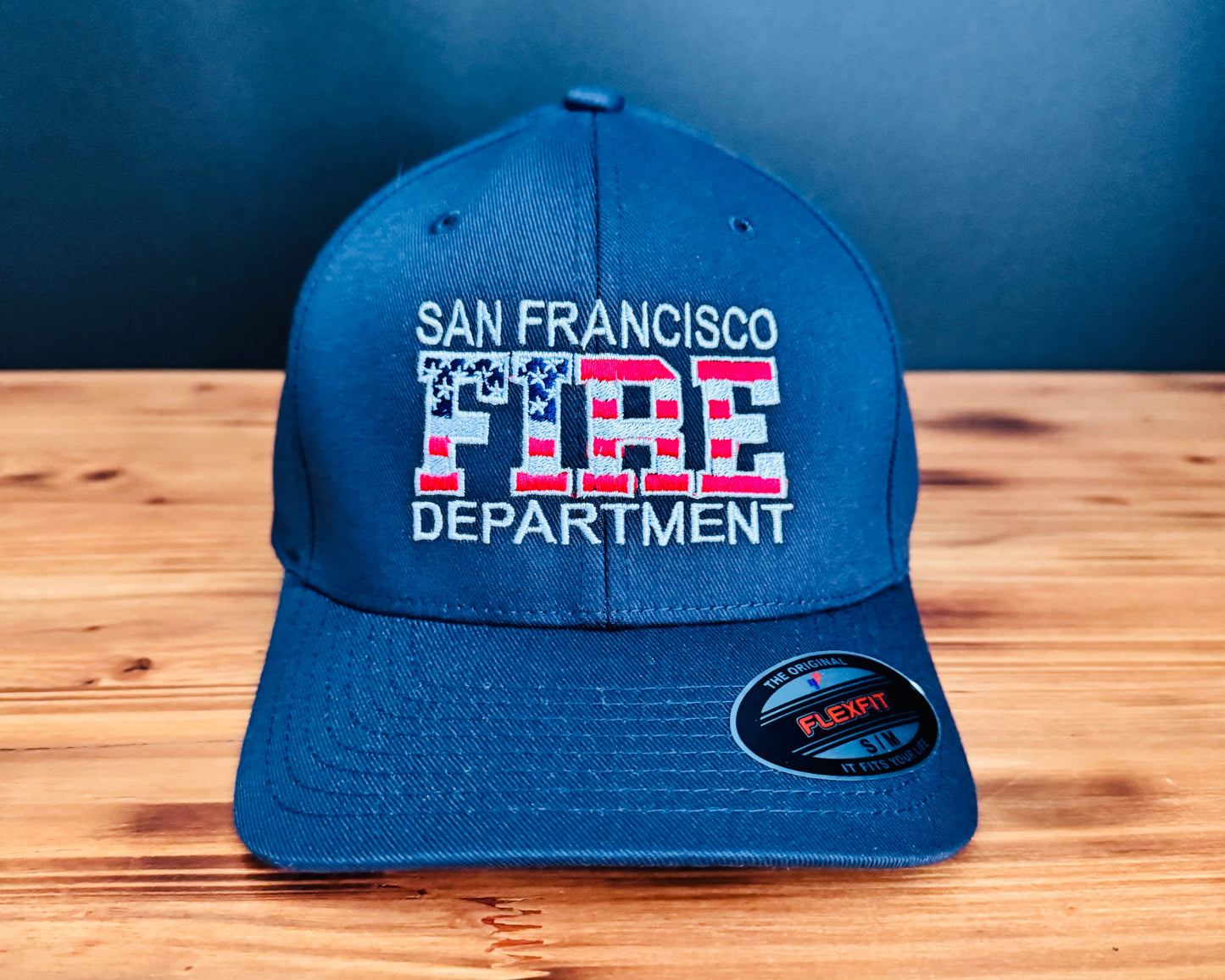 Navy cap with custom Fire Department text and USA flag inside the word FIRE. 