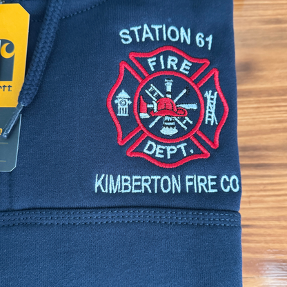 Navy blue sweatshirt with fire department logo and text on a wooden surface